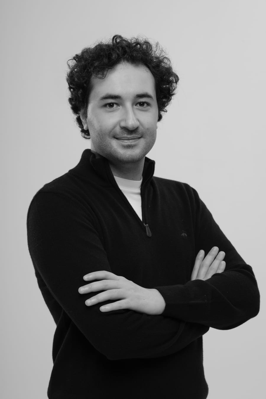 Black-and-white studio portrait of Emre Aydın, founder of AVERNOX